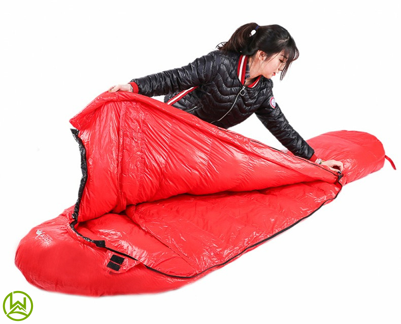 a picture of a lady showing the sleeping bag interior and exterior 